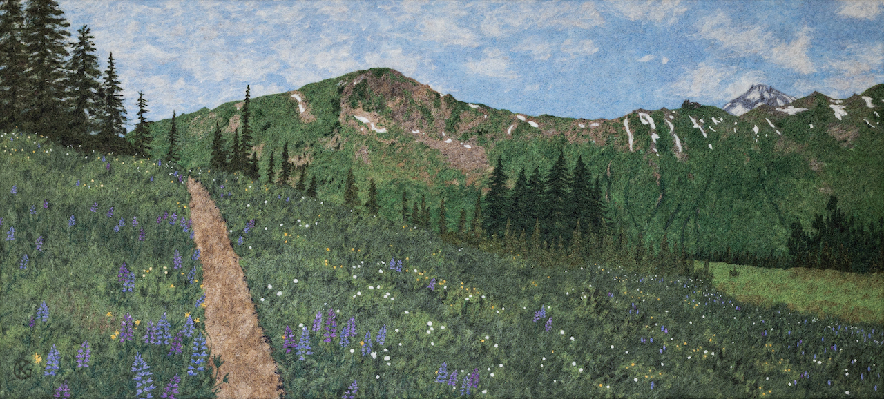 A two-dimensional felted landscape of a mountain ridge in the Northern Cascades and a meadow with lots of blooming lupines.